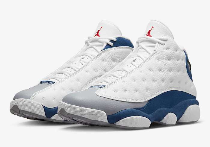 White and blue Air Jordan 13 shoes.